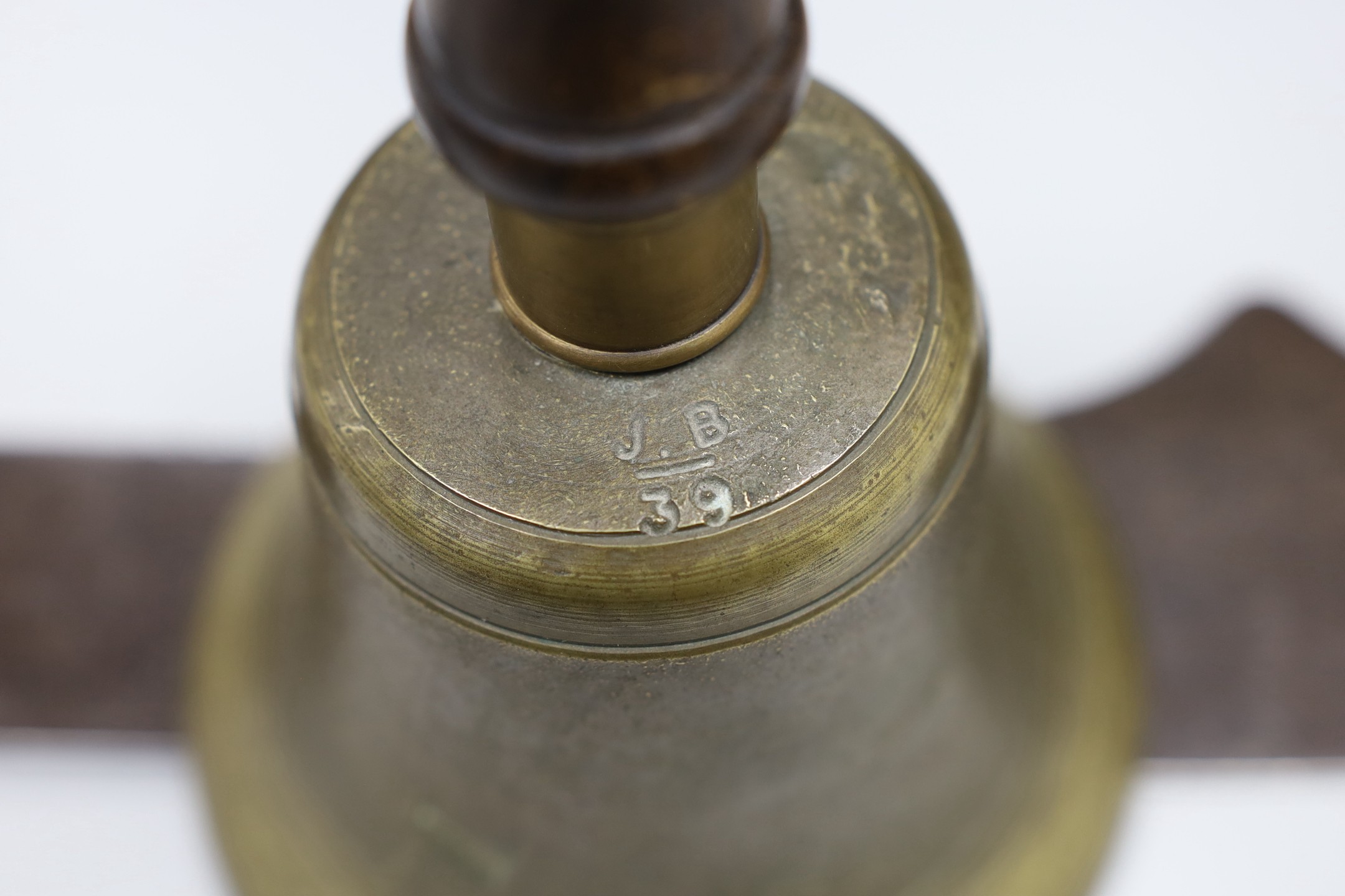 Two canon balls, a brass hand bell marked A.R.P. and a Chinese sword